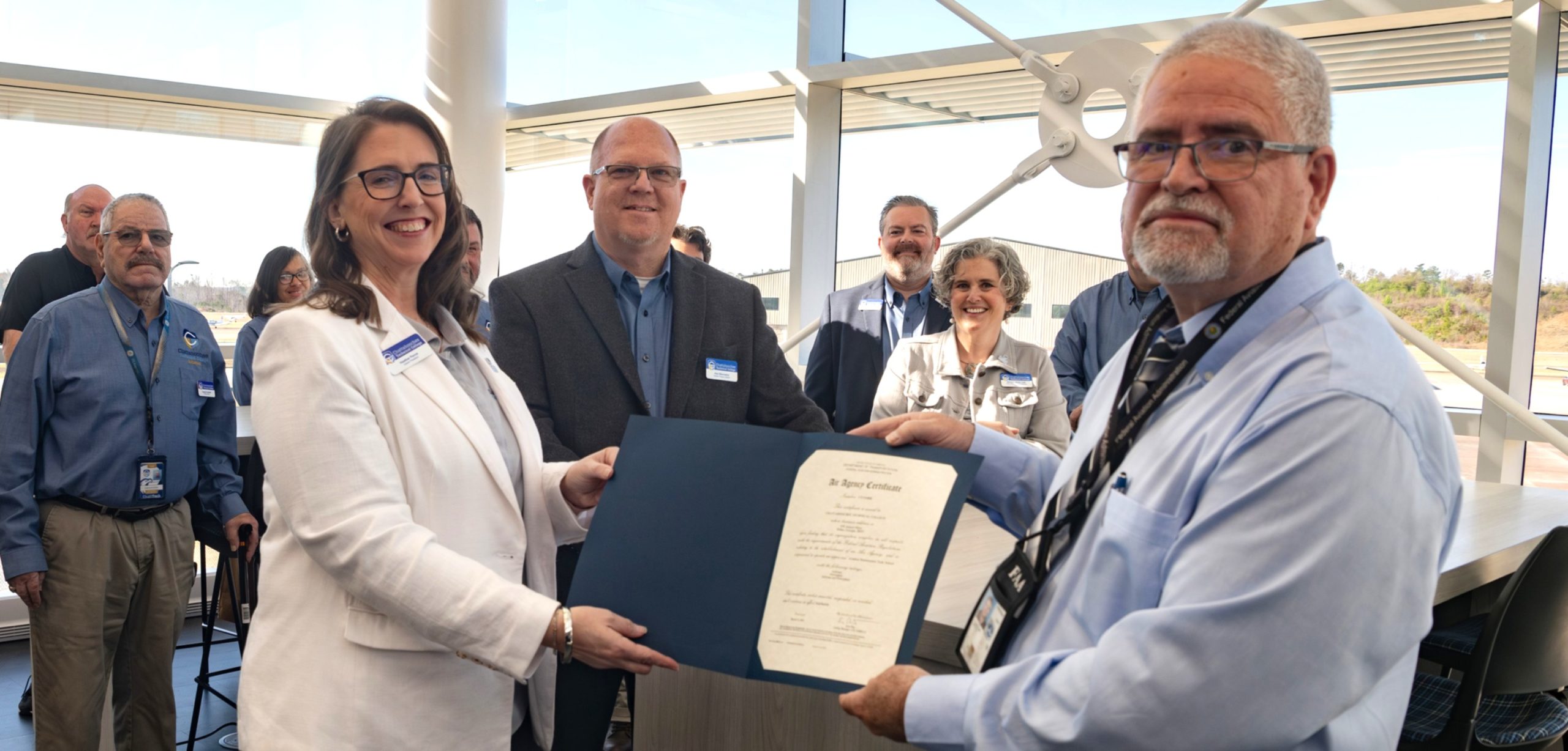 Chatt Tech Interim President Heather Pence and FAA PMI Ricky Flores hold the Air Agency Certificate